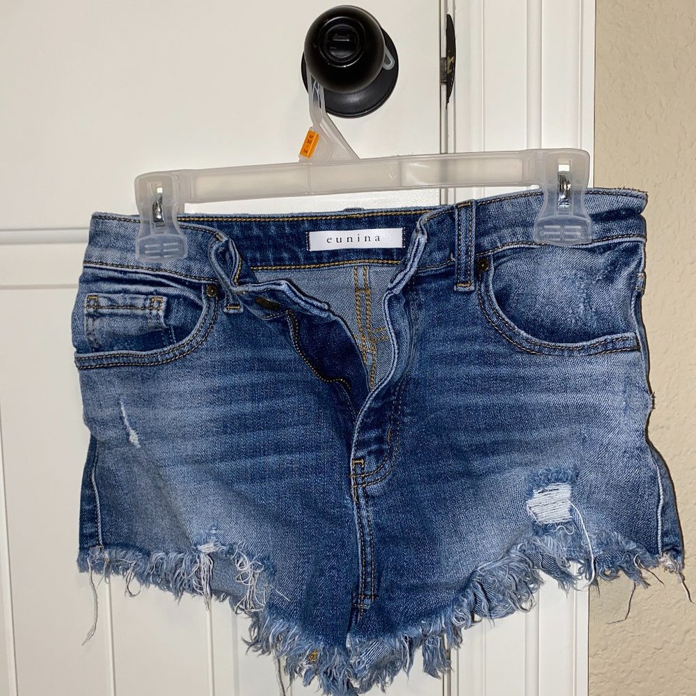 Eunia Jean shorts with frayed ends.